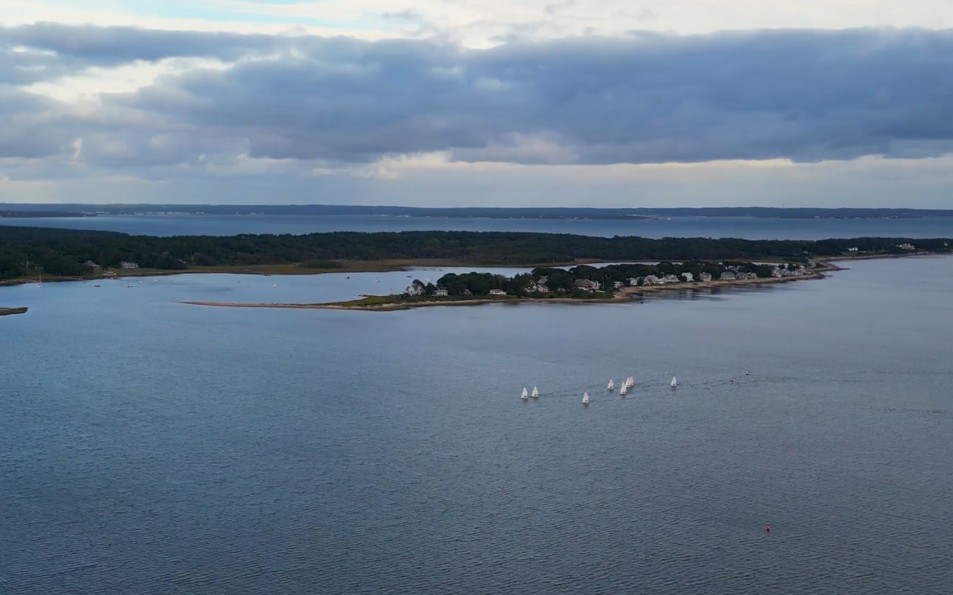 Sailboat on the water along the Buzzards Bay coastline